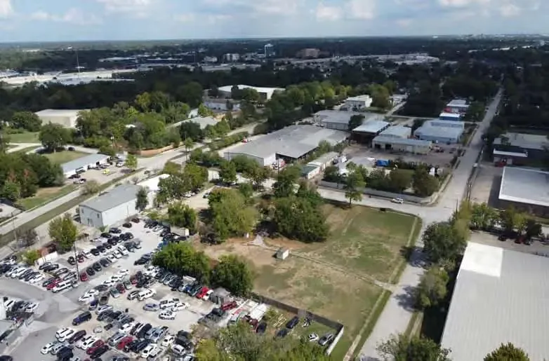 Closer aerial view of the open Dayco Heights lot before construction